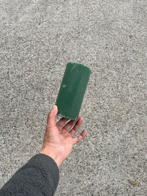 A Lone Green Large Ribbed Candle