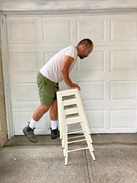 A Tower Of 4 Metal White Stools